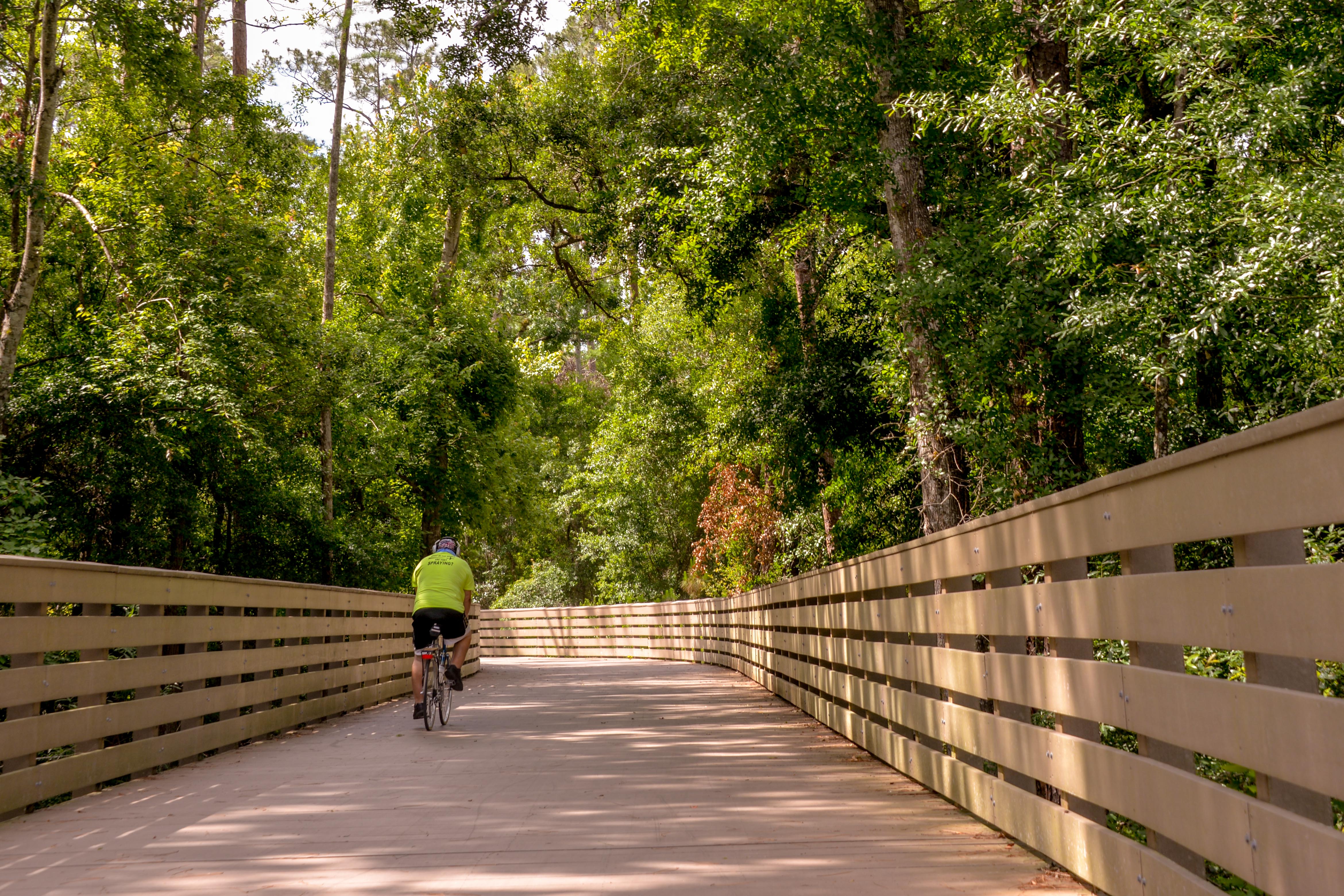 This is a photo of a bike rider on the Shingle Creek Regional Trail in the City of Kissimmee