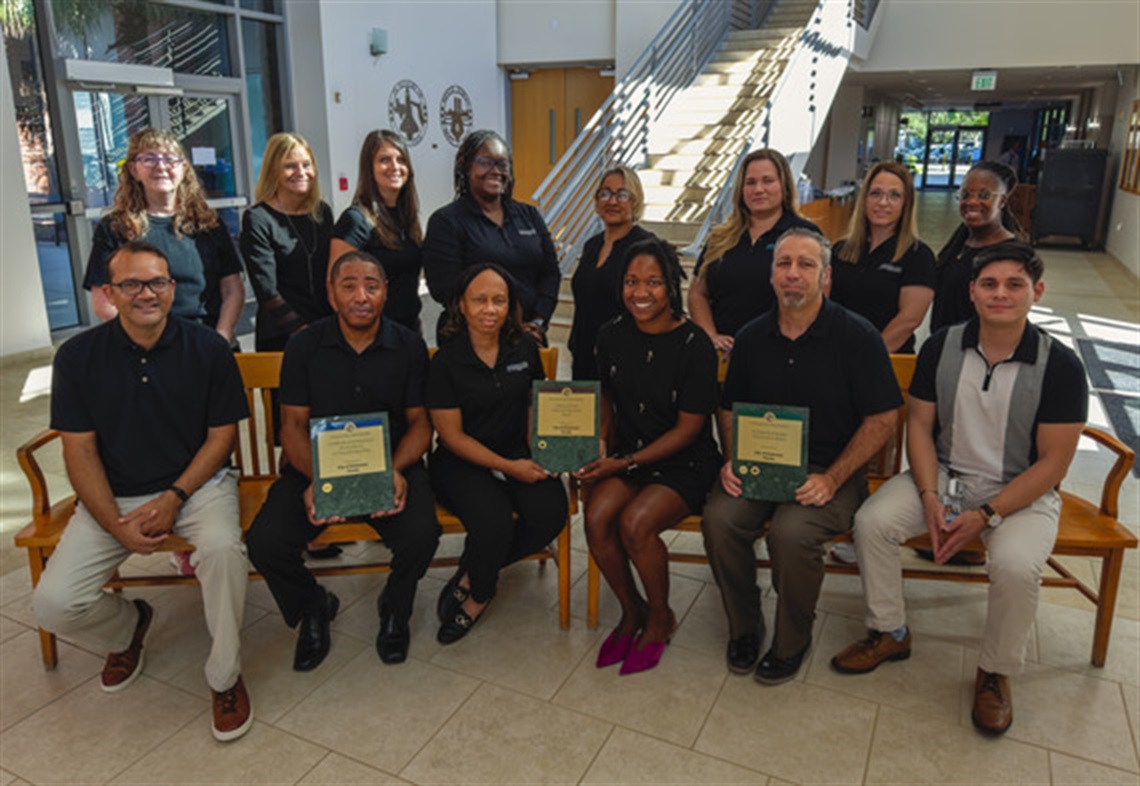 This is a photo of the City of Kissimmee Finance Department holding the Triple Crown Awards